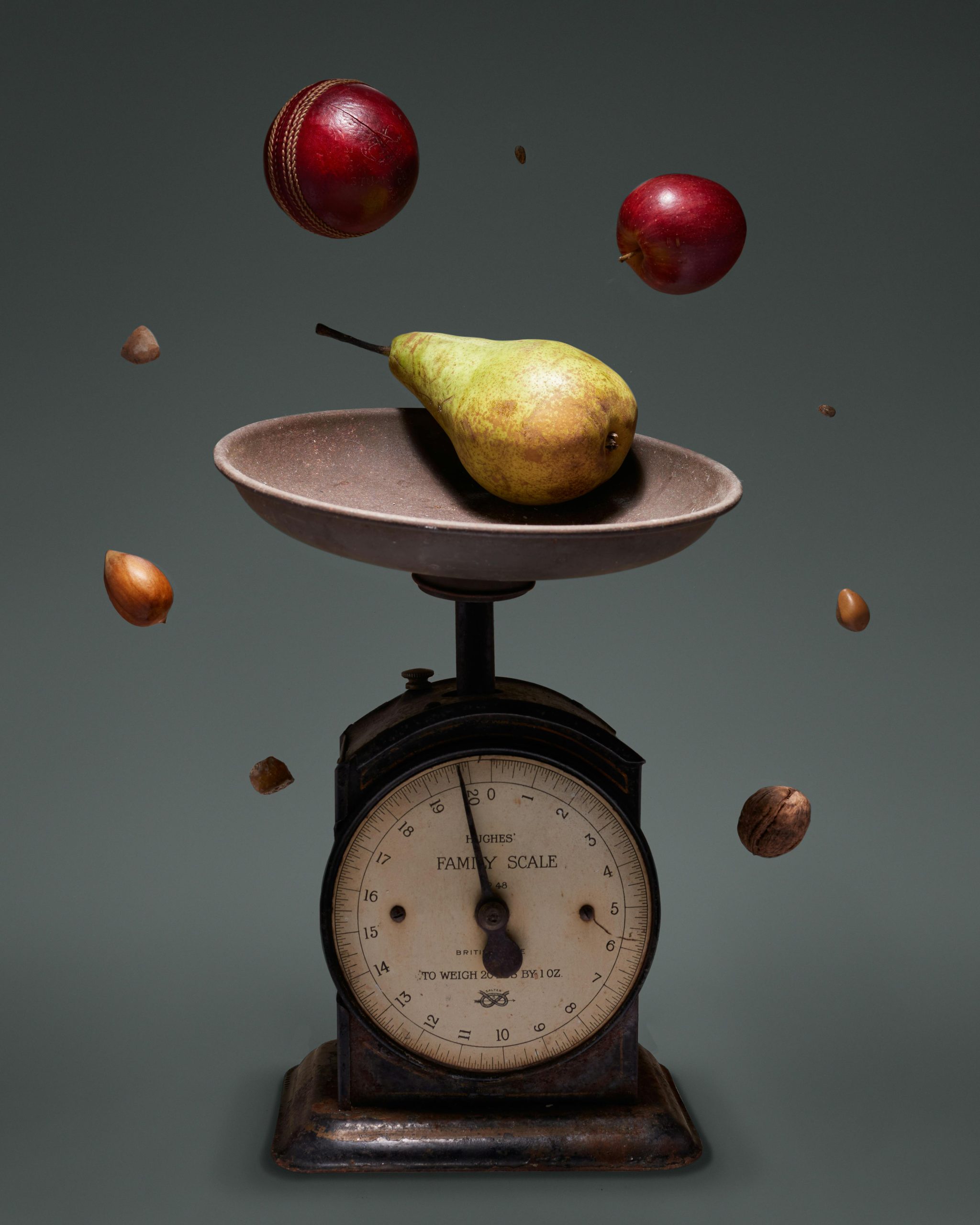 Floating fruit and nuts on a vintage scale symbolizes healthy eating and balance.